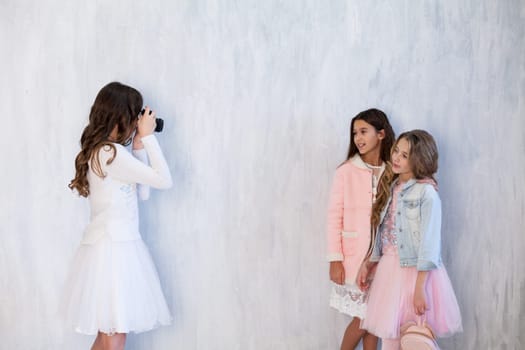 three beautiful fashionable girl girlfriends arranged a photo shoot