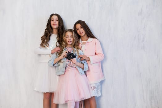 three beautiful fashionable girl girlfriends arranged a photo shoot