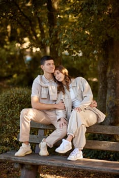 Young Cute Female Hugs Boyfriend. In Autumn Outdoor. Lovers Walking in Park. Attractive Funny Couple. Lovestory in Forest. Man and Woman. Cute Lovers in the Park. Family Concept. Happy Couple.