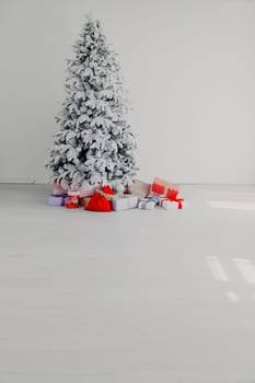 White room Christmas tree with red toys new year winter gifts