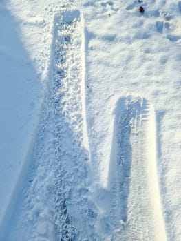 Tire Tracks on snow covered streets in a close up view