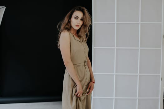 Portrait of a beautiful blonde woman in a beige dress