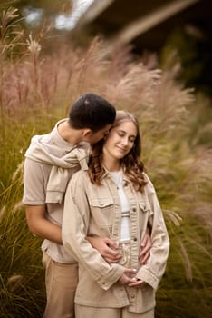 Young Cute Female Hugs Boyfriend. In Autumn Outdoor. Lovers Walking in Park. Attractive Funny Couple. Lovestory in Forest. Man and Woman. Cute Lovers in the Park. Family Concept. Happy Couple.