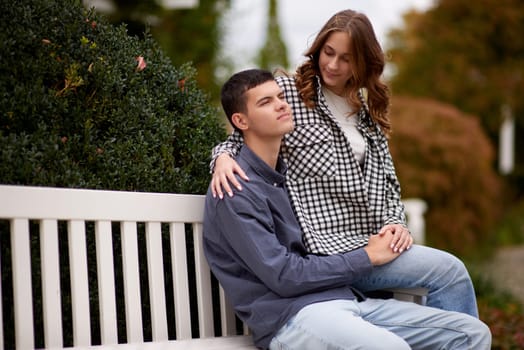 lovely young couple kissing outdoors in autumn. Loving couple walking in nature. Autumn mood. Happy man and woman hugging and kissing in autumn. Love. Fashionable couple outdoors. Fashion, people and lifestyle. Stylish couple in autumn outfit.