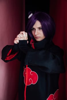 woman anime cosplayer with purple hair