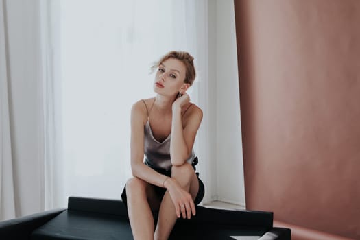 portrait of a beautiful woman on a black office sofa