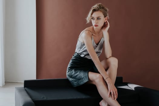 portrait of a beautiful woman on a black office sofa