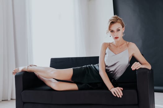 portrait of a beautiful woman on a black office sofa