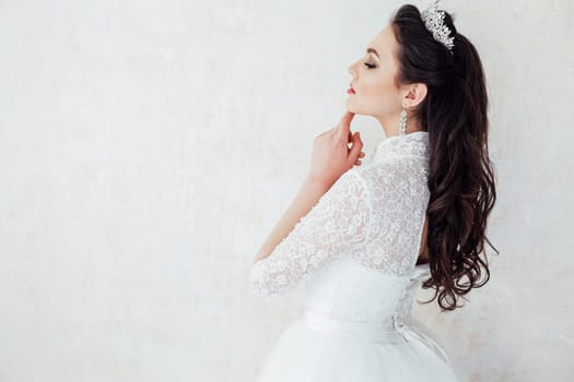 Portrait of a bride in a wedding dress and a Crown of curls hairstyle