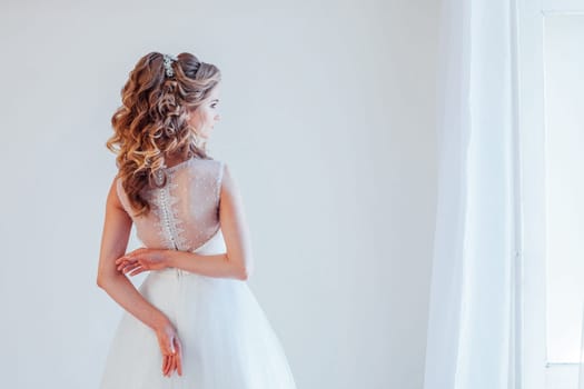 spin the bride in a wedding dress in a white room 1