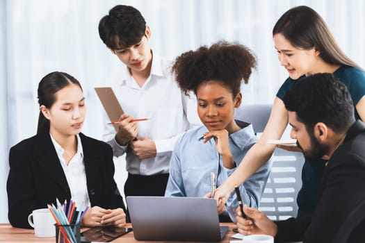 Happy diverse business people work together, discussing in corporate office. Professional and diversity teamwork discuss business plan on desk with laptop. Modern multicultural office worker. Concord