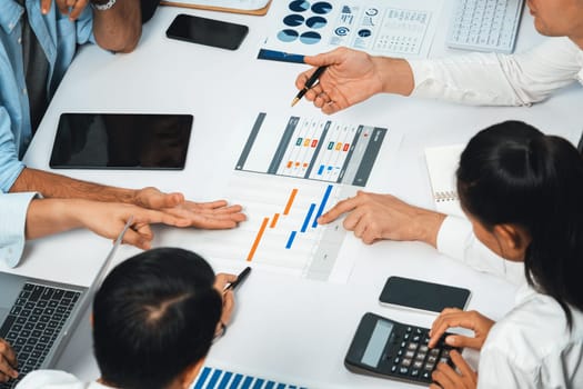 Project manager communicate and collaborate with team using project management software display on monitor, tracking progress of project task and making schedule plan at meeting table. Prudent