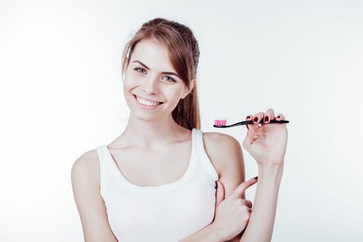 girl with white teeth smiles shows the toothbrush 1