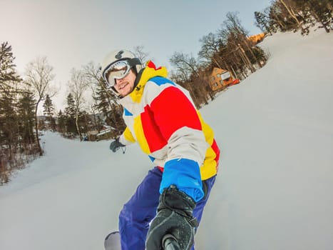 A daring man conquers snowy slopes with style, showcasing skill and thrill as he maneuvers on a snowboard, capturing the essence of winter adventure.