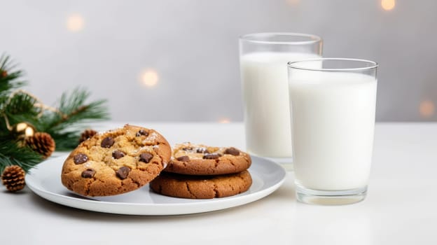 Homemade Christmas gingerbread cookies decorated with sweet sugar icing served on plate With glass of milk on white wooden background.