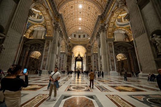 Rome, Italy: 2023 November 14: Inside St. Peter's Basilica, Rome, Italy. St. Peter's Cathedral is the main symbol of Rome and Vatican City. Ornate baroque interior of St. Peter's Church, famous luxury St. Peter's Basilica. Rome.