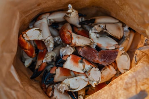 Close-up of a plate with fresh boiled Arctic crab claws, a luxurious and sought-after seafood delicacy, ready to be served. This gourmet dish is popular in fine dining and seafood restaurants.