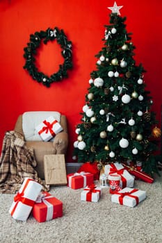 Christmas tree with gifts in the interior of the red room decor for the new year