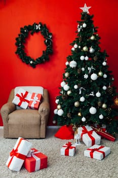 Christmas tree with gifts in the interior of the red room decor for the new year