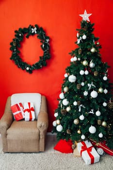 Christmas tree with gifts in the interior of the red room decor for the new year