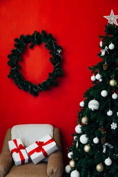 Christmas tree with gifts in the interior of the red room decor for the new year