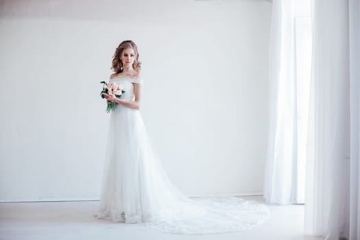 bride in wedding dress holding a bouquet of flowers in her hands