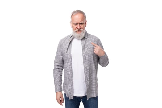 handsome mature man with white beard and mustache dressed in casual comfortable shirt and t-shirt.