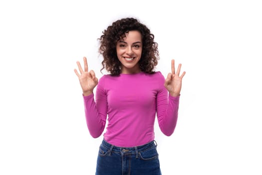 stylish slim young curly brunette woman dressed in a lilac turtleneck.