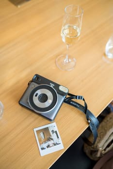 Fujifilm instax square sq6 instant camera lies on the table next to the photograph. High quality photo