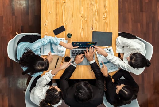 Panorama top view diverse group of business analyst team analyzing financial data report paper on meeting table. Chart and graph dashboard by business intelligence analysis. Meticulous