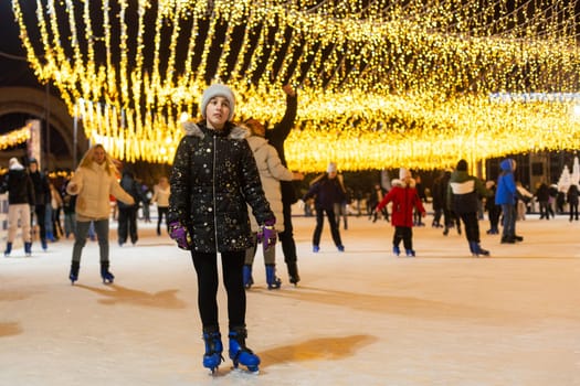 People enjoying ice skating during beautiful winter in the center of city. Merry Christmas and Happy New Year. Holiday and seasonal concept. High quality photo