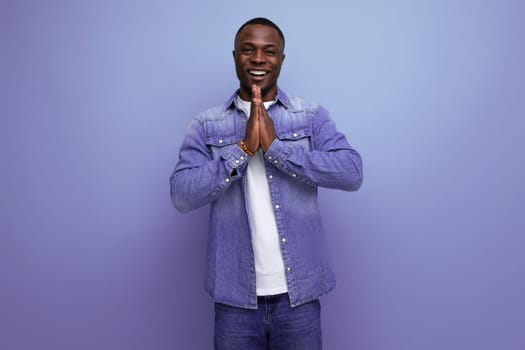 young positive with dark skin american guy dressed stylish isolated studio background.