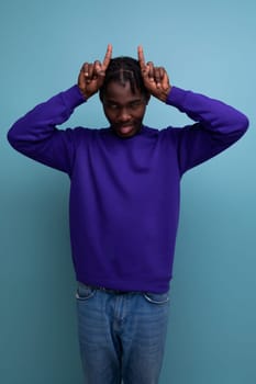 funny american young man with dreadlocks in a blue sweatshirt.