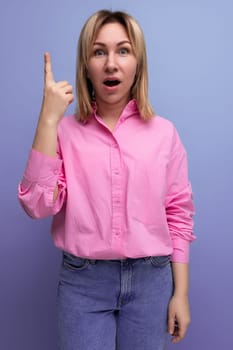 young blond woman with ponytail and glasses dressed in a fashionable pink shirt inspired by the idea.