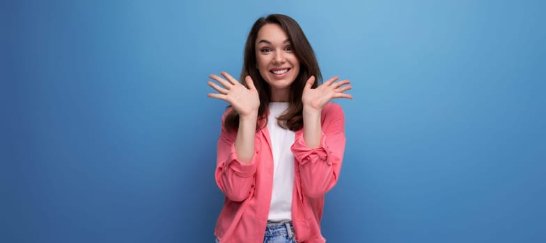 panoramic photo of a long haired brunette young adult in a shirt with cheerful emotions on an isolated background.
