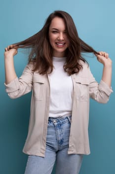 positive cheerful young brunette female adult in casual shirt.