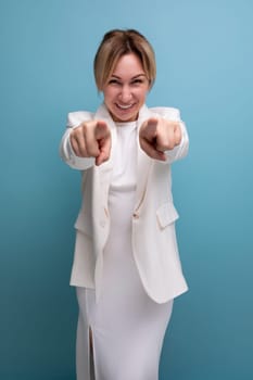 positive slim young caucasian blond lady in white jacket and dress shares ideas.