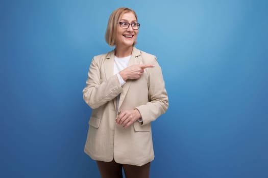 50s business woman in a stylish jacket on a bright studio background with copy space.