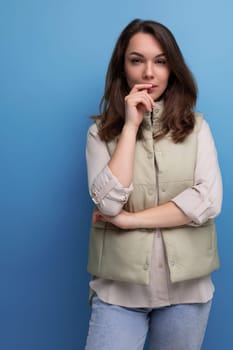 portrait of pretty brunette young woman in shirt and jeans with hair styling.