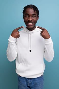 optimist smiling young african guy in white sweatshirt.