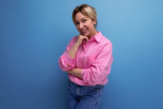 smiling businesswoman in pink shirt on studio background with copy space.