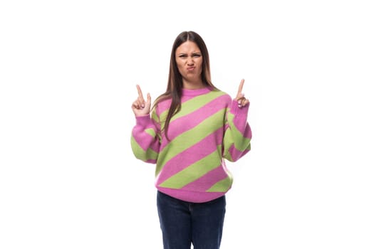 pretty 35 year old feminine model woman dressed in a pink stylish pullover announces the news actively gesticulating.
