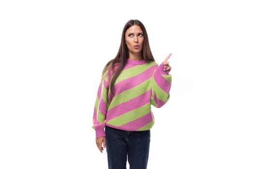 portrait of a young slender well-groomed caucasian woman with black hair dressed in a pink striped jacket on a white background with space for advertising.