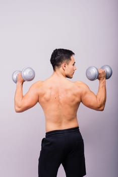 Shirtless bodybuilder showing his great body and holding dumbells.