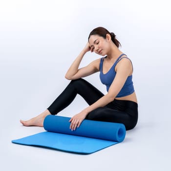 Young attractive asian woman portrait in sportswear with exercising mat. Healthy exercise and workout routine lifestyle concept. Studio shot isolated background. Vigorous