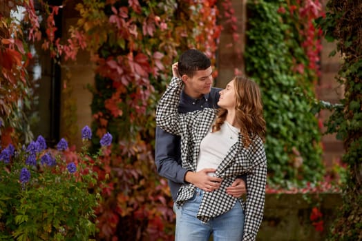 Young Cute Female Hugs Boyfriend. In Autumn Outdoor. Lovers Walking in Park. Attractive Funny Couple. Lovestory in Forest. Man and Woman. Cute Lovers in the Park. Family Concept. Happy Couple.