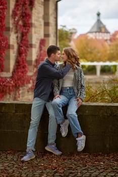 Young Cute Female Hugs Boyfriend. In Autumn Outdoor. Lovers Walking in Park. Attractive Funny Couple. Lovestory in Forest. Man and Woman. Cute Lovers in the Park. Family Concept. Happy Couple.