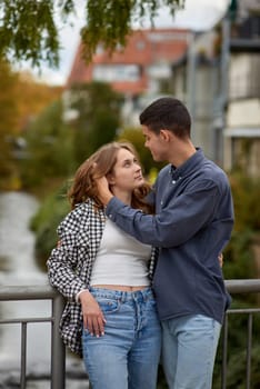 Young Cute Female Hugs Boyfriend. In Autumn Outdoor. Lovers Walking in Park. Attractive Funny Couple. Lovestory in Forest. Man and Woman. Cute Lovers in the Park. Family Concept. Happy Couple.