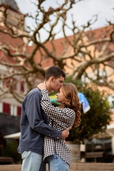 Young Cute Female Hugs Boyfriend. In Autumn Outdoor. Lovers Walking in Park. Attractive Funny Couple. Lovestory in Forest. Man and Woman. Cute Lovers in the Park. Family Concept. Happy Couple.