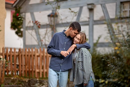 Young Cute Female Hugs Boyfriend. In Autumn Outdoor. Lovers Walking in Park. Attractive Funny Couple. Lovestory in Forest. Man and Woman. Cute Lovers in the Park. Family Concept. Happy Couple.